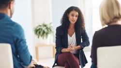 Shot of a young therapist speaking to a couple during a counseling session