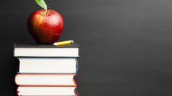 Red apple on a books stack.