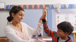 Cropped shot of a teacher helping an elementary school child in class